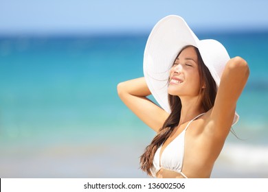 Relaxing Beach Woman Enjoying The Summer Sun Happy Standing In A Wide Sun Hat At The Beach With Face Raised To The Sunlight. Head And Shoulder Portrait. Multicultural Asian Caucasian In Enjoyment.