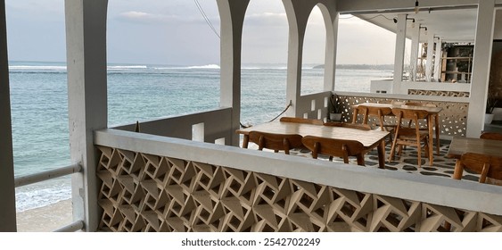 Relaxing Beachfront Cafe with Ocean View and Wooden Table - Powered by Shutterstock