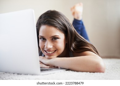 Relaxing And Browsing. Portrait Of A Young Woman Working On A Laptop At Home.