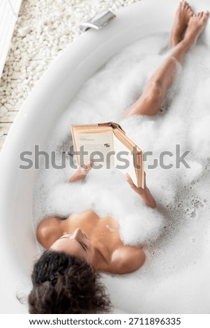 Relaxing in a Bubble Bath While Reading a Book in a Serene Bathroom Setting