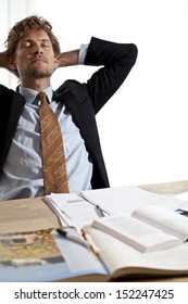 Relaxing Businessman At Desk Taking A Nap Or Just Kicking Back