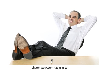 Relaxing Businessman With Feet Up On His Desk