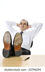 Relaxing businessman with feet up on his desk
