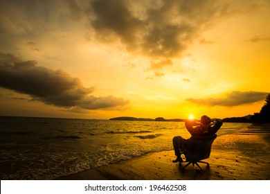 Relaxing businessman sitting on beach, Success in business concept - Powered by Shutterstock