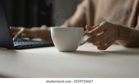 Relaxing Coffee Break While Working from Home at Cozy Office Desk with Laptop Warm Atmosphere Focus on Productivity and Comfort