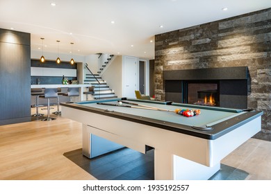 Relaxing with colourful chairs, pool table, fireplace, tv and bar