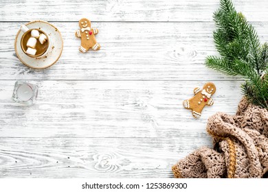 Relaxing, Cozy Winter Evening Concept. Hot Mug Of Cocoa Near Christmas Gingerbread Man, Fir Branches, Wool Blanket On White Wooden Background Top View Space For Text