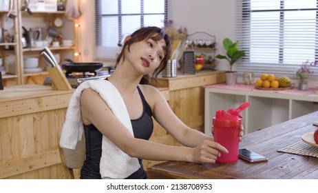 Relaxing In Dining Room After Run. Portrait Slender Girl Prizing Off Tumbler Lid And Drinking Refreshing Water. Genuine Lifestyle