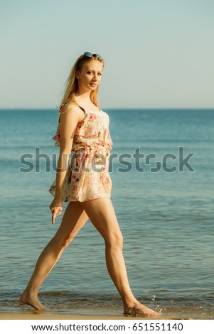 Similar – Young, long-legged woman sitting on the Baltic Sea beach