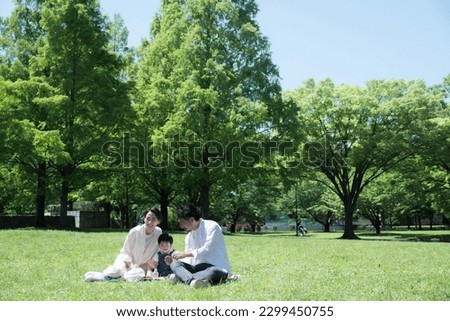 Relaxing and friendly family in the park with copy space available	