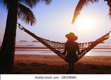 Relaxing In Hammock At Sunset On The Paradise Beach