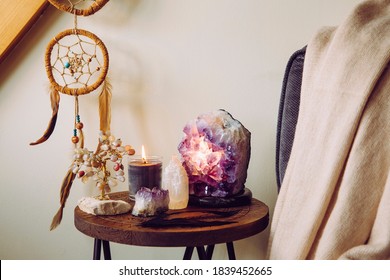 Relaxing Home Shrine With Relaxing Objects, Amethyst Cluster Geode Lamp Illuminated, Scented Candle Burning, Selenite Tower Stone, Crystal Wire Tree And Dream Catcher.