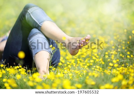 Relaxing in a meadow full of buttercups in the summer sun