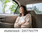Relaxing moment of beautiful woman sleeping in car back seats with safety belt. Female happy in car while traveling on the road to your destination.