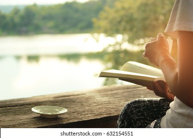 Relaxing moments , Cup of coffee and a book on wooden table in nature background, color of vintage tone and soft focus. - Powered by Shutterstock