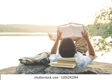 Relaxing moments, Young boy opening and reading a book. Relax time on holiday concept travel, Thailand.