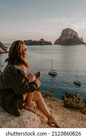 A relaxing scene of a small rocky island Es Vedra at sunset in Ibiza.