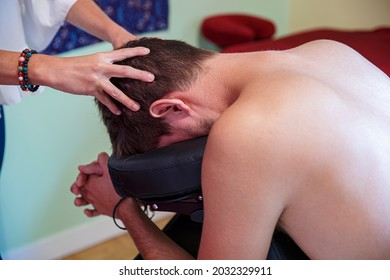 Relaxing therapeutic massage of human head by a professional woman.