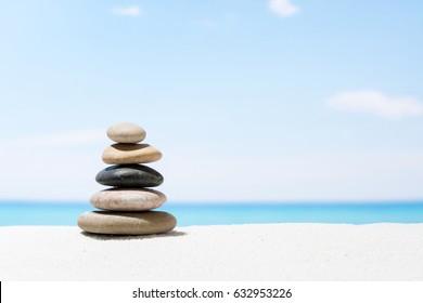 Relaxing in the tropical beach, with white sand and stack of stones