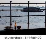 Relaxing view from the decorative railings of the house boat in Kerala along with the cups of tea and bowl of snacks and sauce bottle 