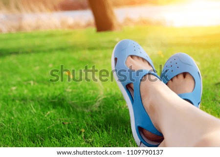 Relaxing young woman in a meadow in the summer sun