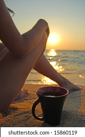 Relaxing Young Woman On A Beach With A Cup Of Coffee