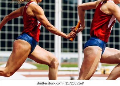 relay race passing of baton women team runners