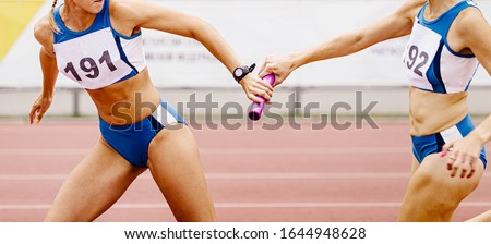 relay race passing of baton women relay team in athletics