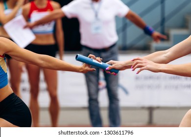 relay race racing women runners in track and field - Powered by Shutterstock