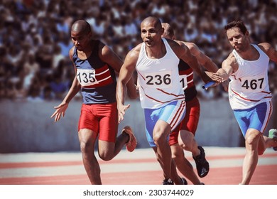 Relay runners exchanging batons on track - Powered by Shutterstock