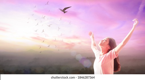 Release And Freedom Concept: Beautiful Girl Over Sky And Bird Flying Sunset Background