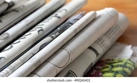 Release Press Newspapers Stack Pile Of Old Business Newspaper  On Wooden Table