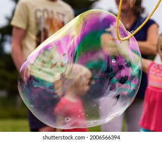 Releasing huge colorful soap bubbles in the open air