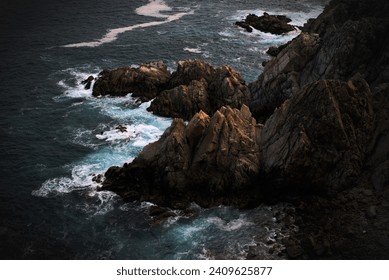 The relentless force of the waves embraces the cliffs in an eternal symphony