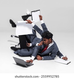 Relentless multitasking demands of corporate life. Businessman in suit balances various office tools, including documents, phone, and laptop Concept of business, professionalism, multitasking. Ad - Powered by Shutterstock