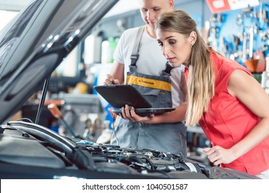 Reliable auto mechanic showing to a female customer the engine error codes scanned by a car diagnostic software in a modern automobile repair shop - Powered by Shutterstock