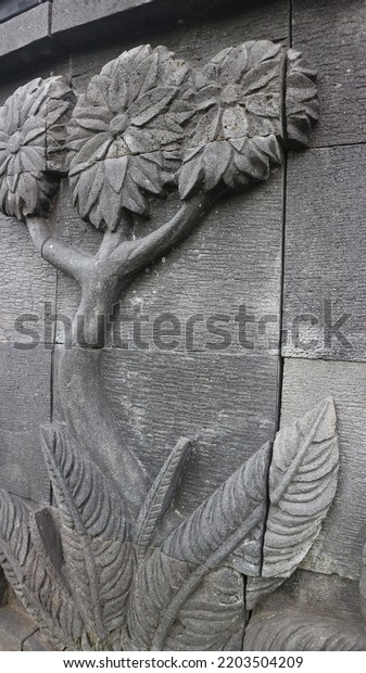 Relief carving of a stone. Relief wall. Stone\
wall decoration.