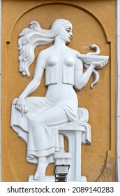 The relief of a greek goddes with bowl of hygeia above the entrance to the old pharmacy in Lviv, Ukraine