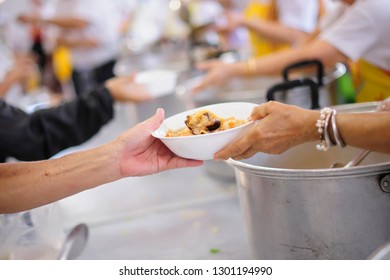 Relief of hunger for homeless people with free charity food - Shutterstock ID 1301194990