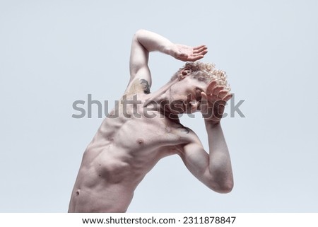 Relief male torso. Portrait of muscular shirtless man with curly blond hair posing in underwear isolated over white studio background. Concept of antique sculpture, body aesthetics, men's beauty, art