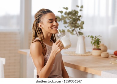 Relieved After Workout. Slim Appealing Woman Feeling Relieved After Finishing Workout While Drinking Protein Shake