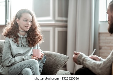 Relieved At Counseling. Pleasant Appealing Curly Teenager Feeling Relieved During Counseling