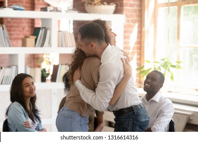 Relieved man and woman hugging giving psychological support empathy during group therapy session, friends people embracing comforting helping overcome problems addiction at psychotherapy counseling