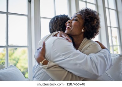 Relieved Mature Woman Embracing Her Family Doctor.