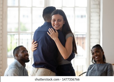 Relieved Reconciled Married Couple Man And Woman Embrace Feel Healthy Happy Give Psychological Support Empathy During Group Therapy Session, Friends People Hug Helping In Rehab Recovery Concept