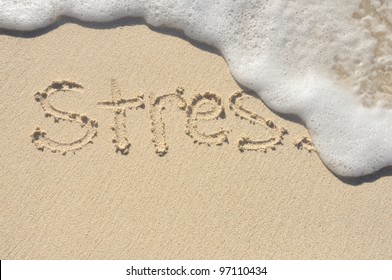 Relieving Stress, the Word Stress Being Washed Away by a Wave on a Beach