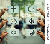 Religion conflicts as global issue concept. Human hands holding different paper with faith symbols over crowded street scene. Relations between different people doctrines and beliefs, social problem.