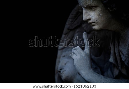 Religion and death concept. Ancient statue of an angel as symbol of end of life. Horizontal image.