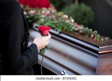 Religion, death and dolor  - funeral and cemetery; funeral with coffin - Shutterstock ID 87196501