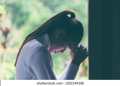 Religion, faith and people concept. Woman Pray for god blessing to wishing have a better life. begging for forgiveness and believe in goodness. Christian life crisis prayer to god. - Powered by Shutterstock